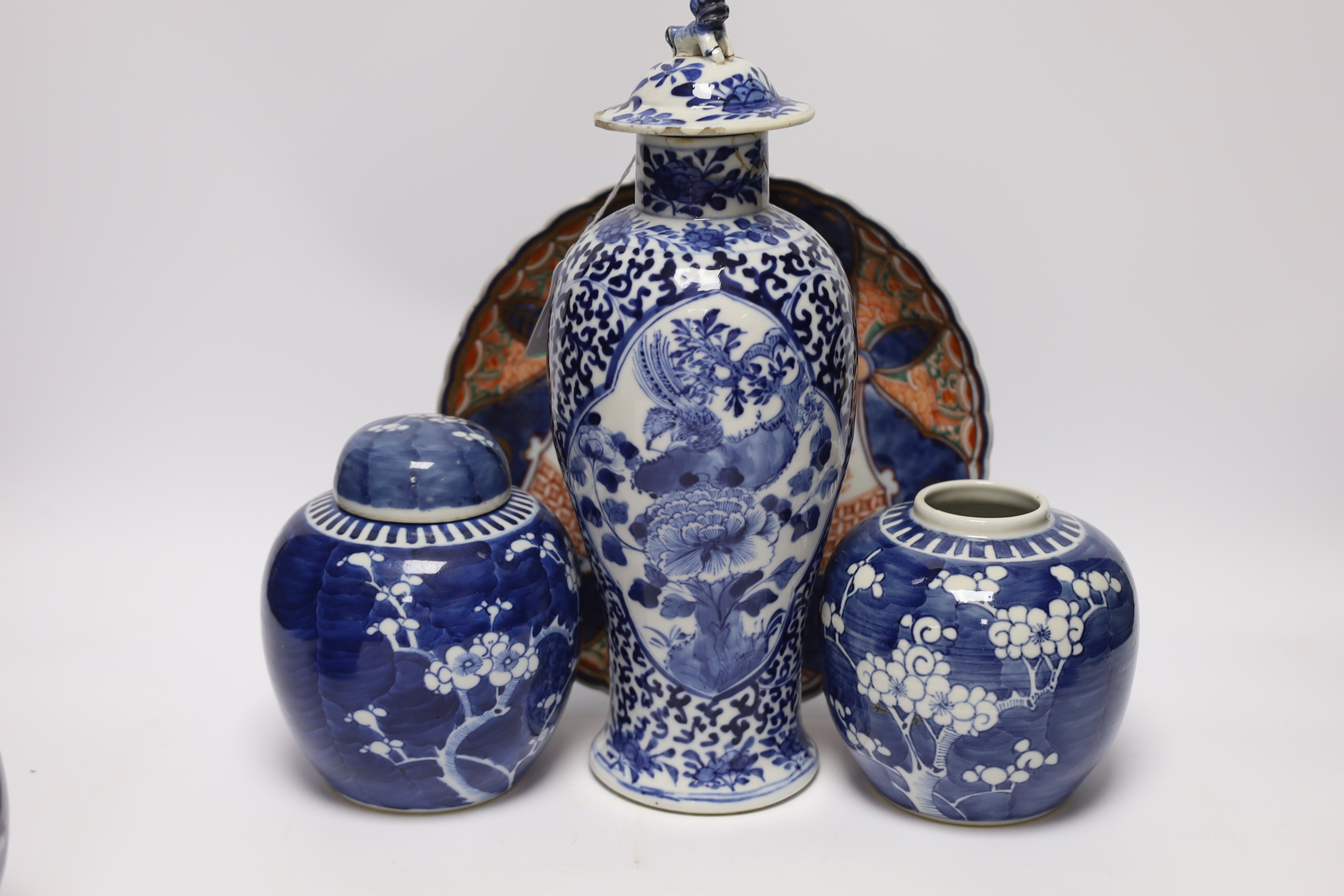An early 20th century Chinese blue and white vase and cover, pair of 19th century Chinese famille rose dishes, four prunus jars, two covers, a Japanese Meiji period Imari dish and a small satsuma pot, some damage, talles